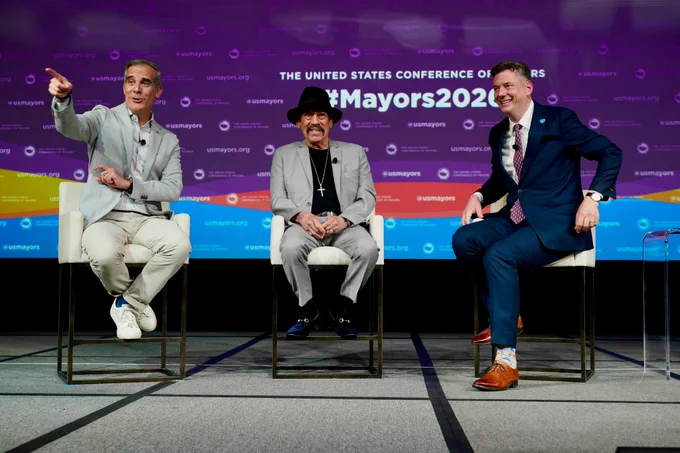 Former Los Angeles Mayor Eric Garcetti, Danny Trejo, and USCM President David Holt having a conversation on stage.