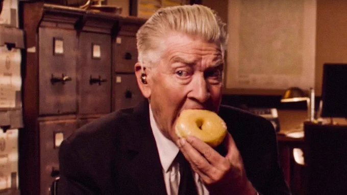 David Lynch, as Gordon Cole in the third season of TWIN PEAKS (2017), getting ready to absolutely crush a glazed donut.