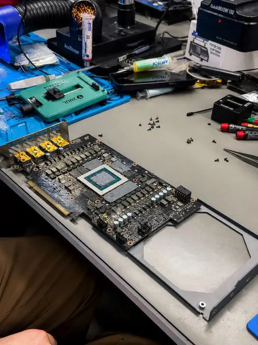 RTX 4090 GPU disassembled on repair bench, showing exposed core and components during advanced board‑level diagnostics and GPU repair work.