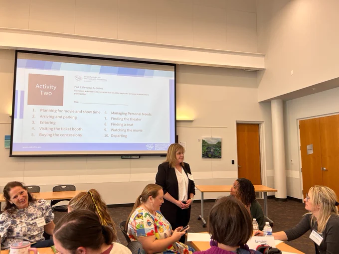 Betsy Eiserman, Accessible Ohio Specialist, talks with workshop participants during the social narrative session.