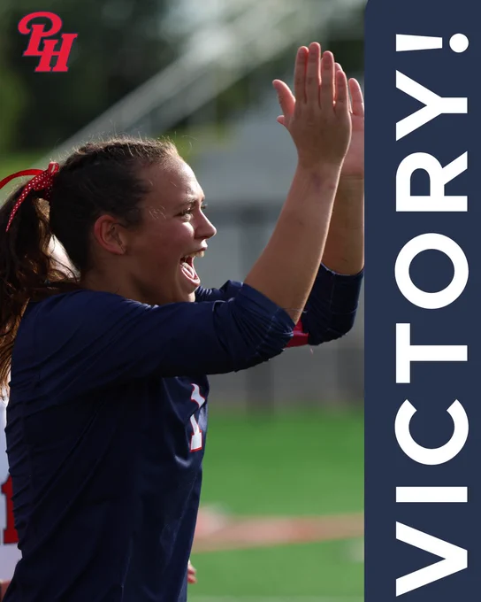 A female athlete passionately celebrates a victory with a wide smile and raised hands. The image captures a moment of triumph and joy on a sports field.