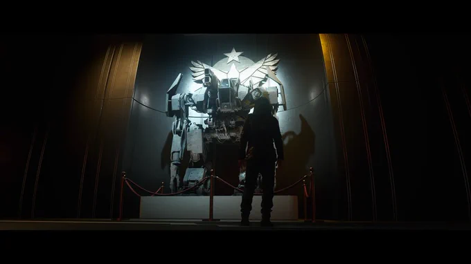 A lone figure stands facing a large robotic structure displayed against a wall adorned with the Freestar Collective logo.