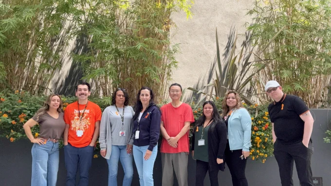 Housing Department staff pose for a photo, wearing orange ribbons in honor of National Gun Violence Awareness Day.