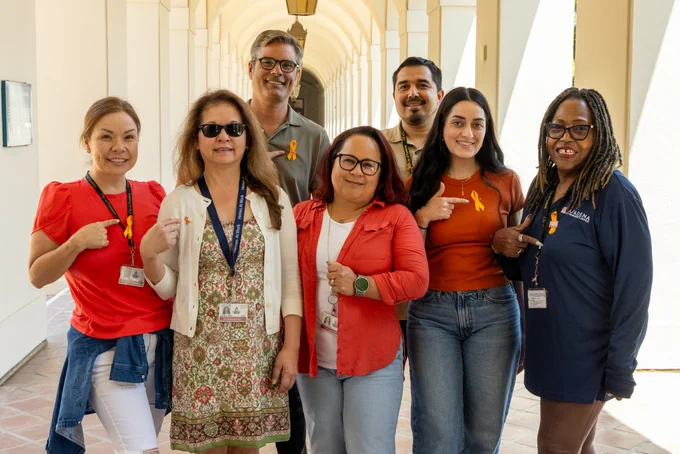 City Manager's Office staff pose for a photo showing off their Orange Ribbon in honor of  National Gun Violence Awareness Day. 