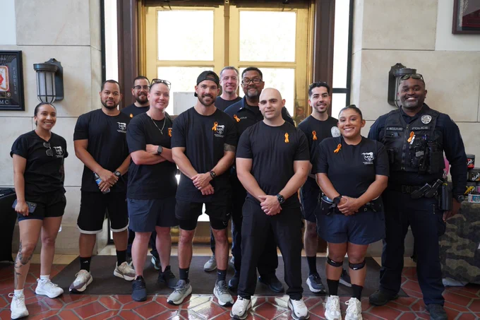 Pasadena Police Department employees pose for a group photo showing off their orange ribbons in honor of  National Gun Violence Awareness Day. 