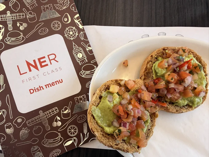 Avocado and pico de gallo on a muffin on a plate