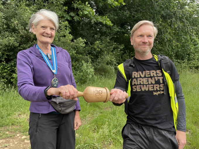 Dame Fiona Reynolds, High Sheriff of Gloucestershire hands over the Thames Path Relay Baton to Paul Flynn of the Blue Human Project