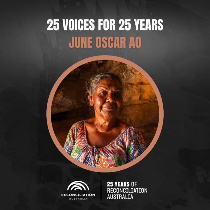 The image features June Oscar in a colorful top, smiling in front of a rocky background. The text reads "25 Voices for 25 Years". The logo for Reconciliation Australia is displayed along with the phrase "25 Years of Reconciliation Australia."
