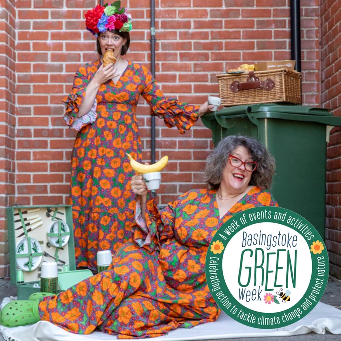 Two women in floral dresses having a picnic, with a Basingstoke Green Week logo