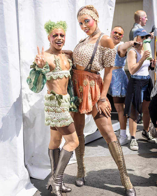 Two cast members of Cabaret posing together backstage at West End LIVE and one is holding up a peace sign.