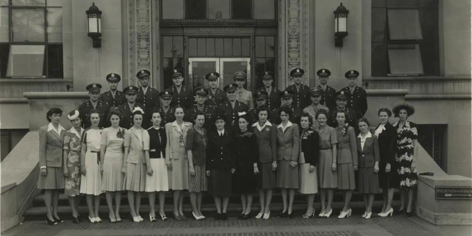 Doctors, nurses and dietitians from the University of Michigan Army 298th hospital pose on the steps of University Hospital before deployment June 1942