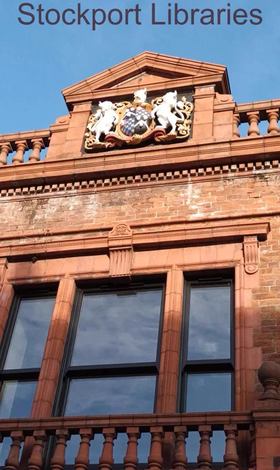 Red brick building facade with coat of arms and ornate stonework.