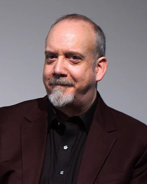 A professional headshot of Paul Giamatti. 