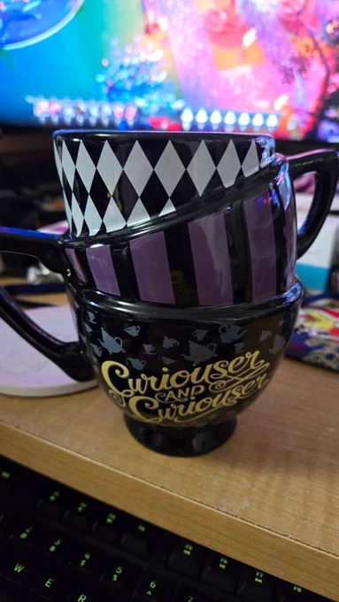 An alice in Wonderland themed mug that looks like three stacked mugs