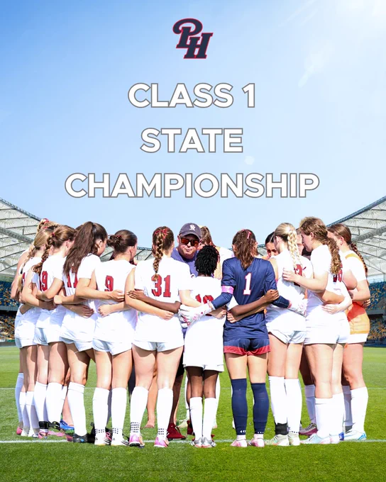 A girls' soccer team huddles on the field, preparing for the Class 1 State Championship. The team exhibits unity and determination under a clear blue sky.
