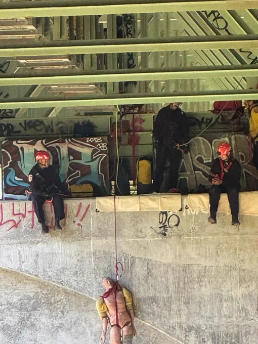 Firefighters and dummy on bridge