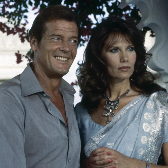 Roger Moore (James Bond) and Maud Adams (Octopussy) in between takes on the set of Octopussy.