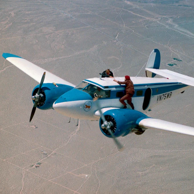 Stuntmen Jake Lombard (doubling for James Bond) and B.J. Worth (doubling for Gobinda) film the climactic fight sequence on top of a plane in Utah.