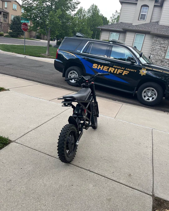 Emotorcycle next to patrol vehicle 