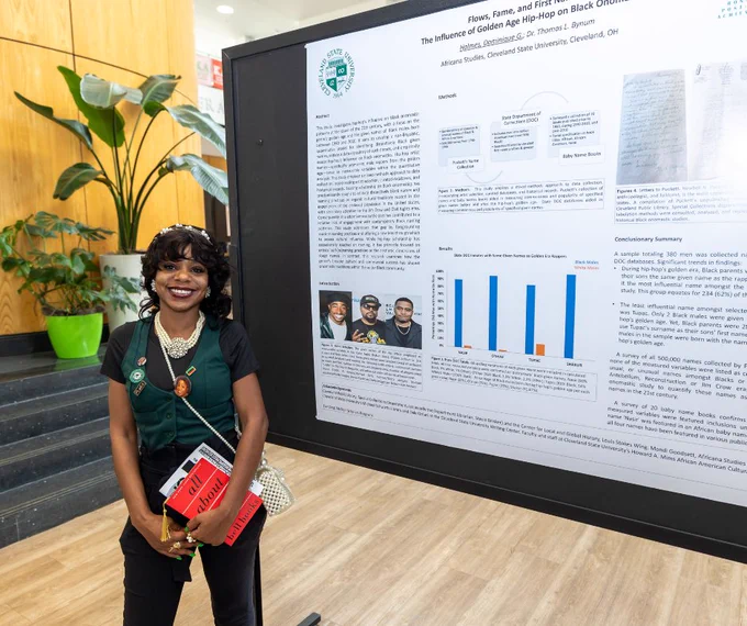 CSU student standing in front of a research poster presentation.