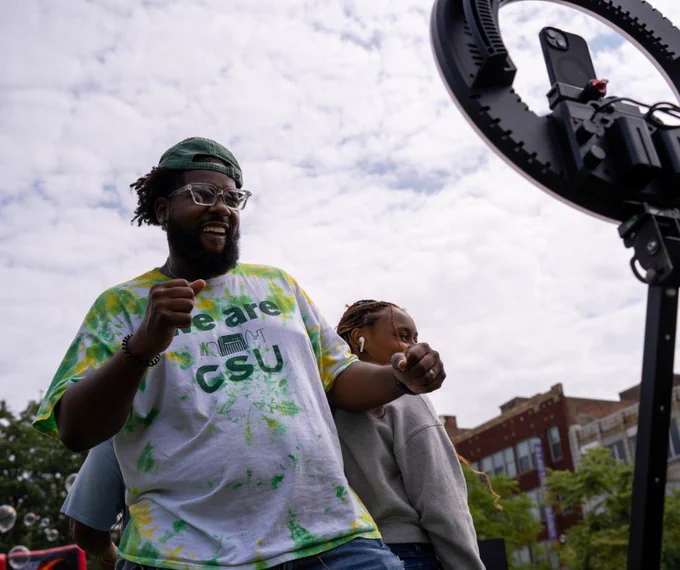 Two students dancing in front of a phone on a tripod at VikesFEST. 