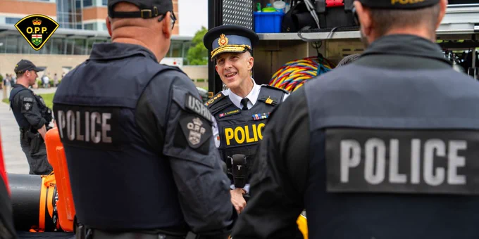 OPP Commissioner Thomas Carrique speaks to two uniformed OPP USRT officers at OPP Family and Veterans' Day event