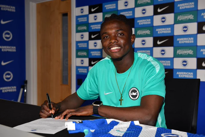 Zadok Yohanna smiles whilst signing his contract. 