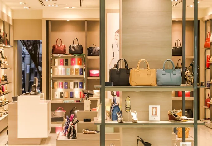 Cover image illustrating: Saks Global's bankruptcy restructuring after a disastrous merger with Neiman Marcus left the luxury retailer with massive debt and deteriorated supplier relationships.