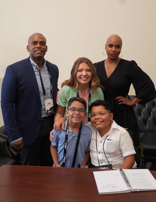 Rep. Ayanna Pressley poses for a photo with Adrian and his family.