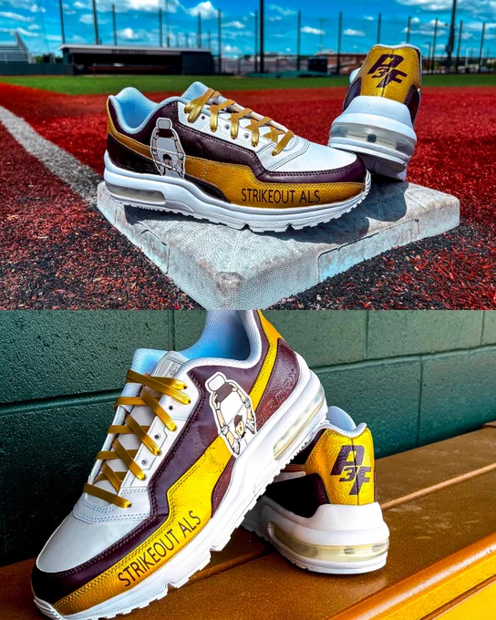 A pair of custom sneakers with a baseball theme displayed on a base and near a bench. The shoes feature illustrations of Scooby-Doo and the phrase "Strikeout ALS" on a baseball field. The shoes are white, brown, and yellow.
