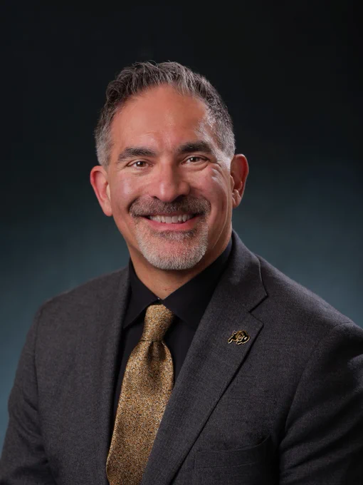 Chancellor J's headshot with CU Boulder, current chancellor