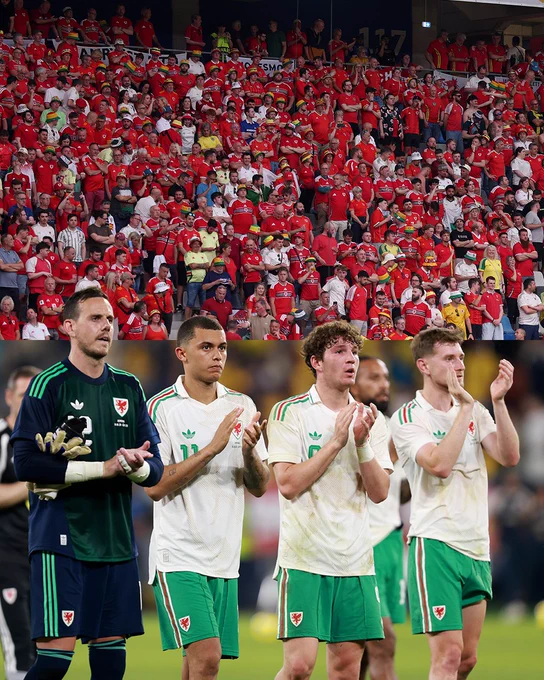 Cymru players applaud The Red Wall in Bucharest.
