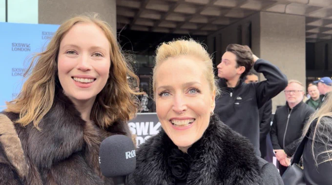 Gillian Anderson and Hannah Einbinder smiling at the camera on the red carpet