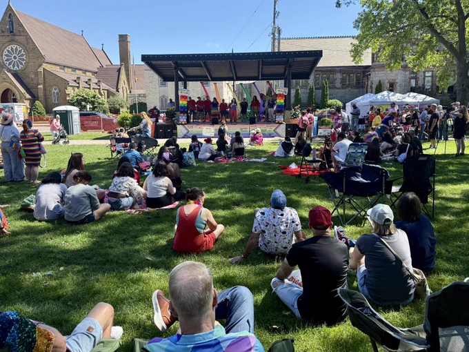 AG Nessel speaks from stage to audience in field at Muskegon Pride