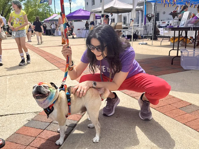 AG Nessel pets rainbow pug at Lowell Pride