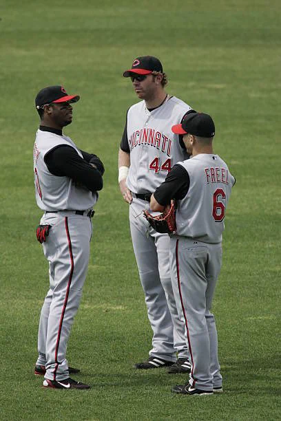 @redsdaily: Ken Griffey Jr., Adam Dunn, and Ryan Freel chat during a pitching change at an away game. via Reds Daily @getredsdaily