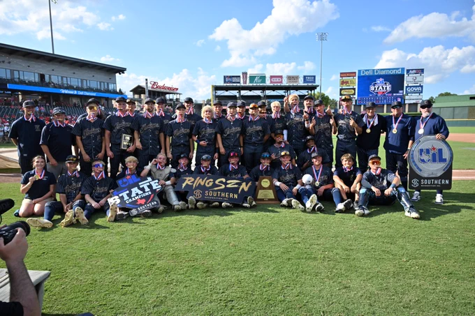 Keller team and coaches pose with championship trophy and signs.
