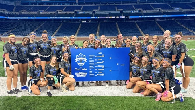 flag football team posing with backet 
