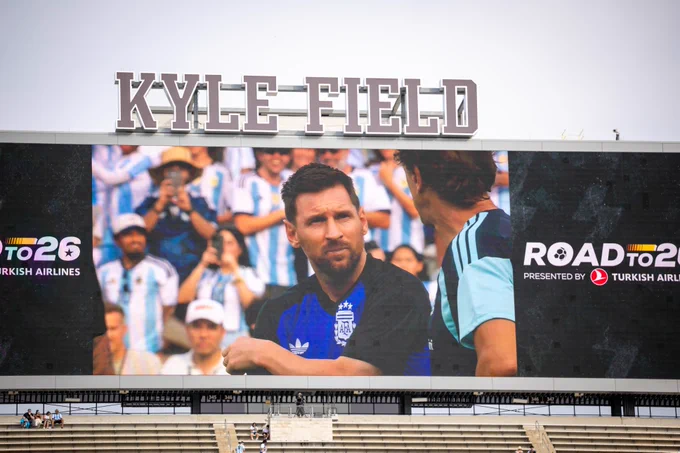 A large stadium screen at Kyle Field displays a soccer player in an Argentina jersey during an event presented by Turkish Airlines. The text "ROAD TO 26" is visible on the screen.