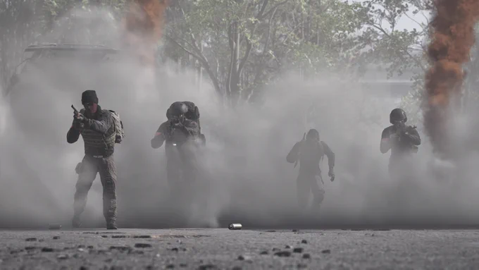 In-Game screenshot of WARDOGS players walking and running through smoke.