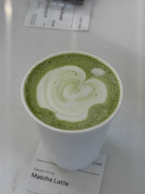 Photo of a Matcha Latte with the Apple logo milk effect.