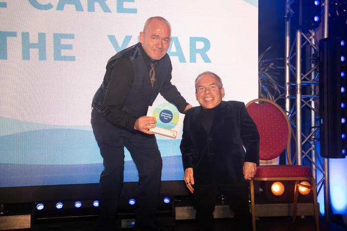 Photo of last year's Proud to Care Cornwall Awards Social Care Nurse of the Year, Scott Hulin, with actor Warwick Davis, who presented the awards.