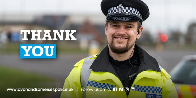 A uniformed police officer with a hi-vis jacket on smiling at the camera alongside the words "thank you".