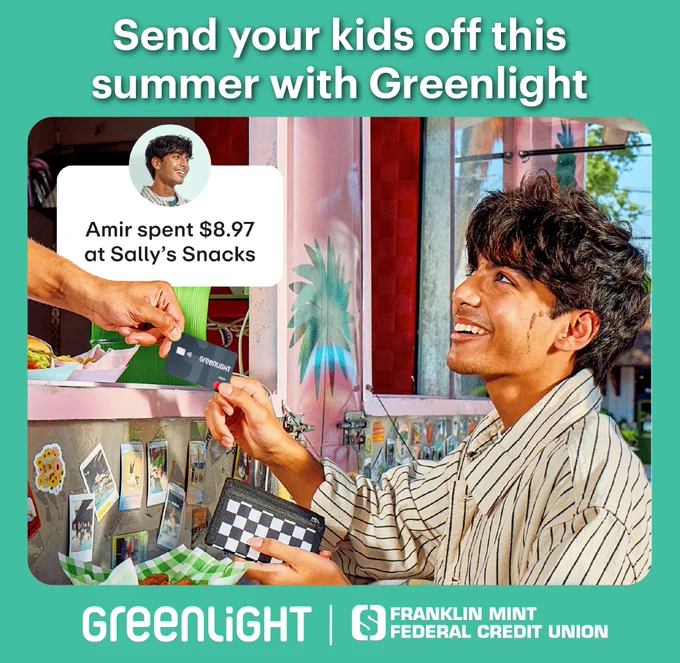Teenage boy handing Greenlight debit card to a food truck worker with Greenlight and FMFCU Logos below