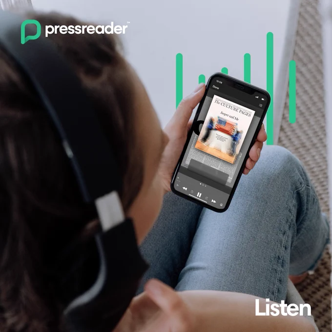 Person wearing headphones listens to an PresssReader on a smartphone while sitting cross-legged indoors.