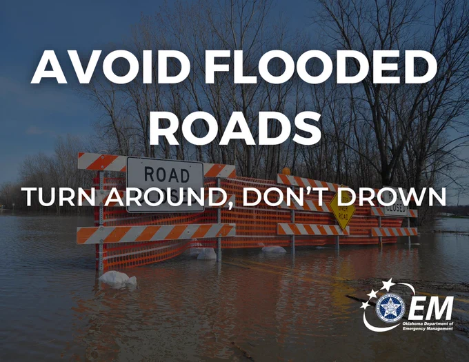 Image shows a flooded roads with barricades across it. The text says: Avoid flooded roads. Turn around, don't drown.
