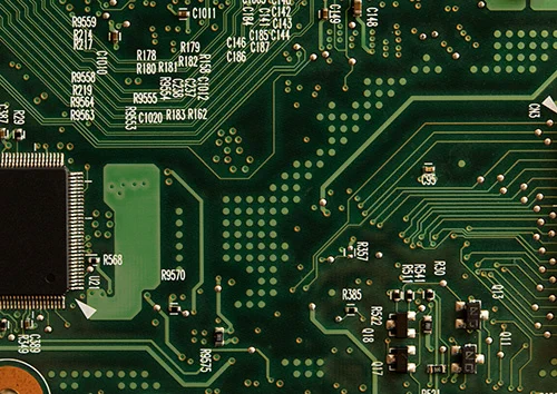 circuit board with many small unconnected green dots on its surface
