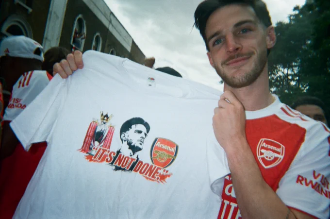 Declan Rice holding up a t-shirt with his quote "It's not done."