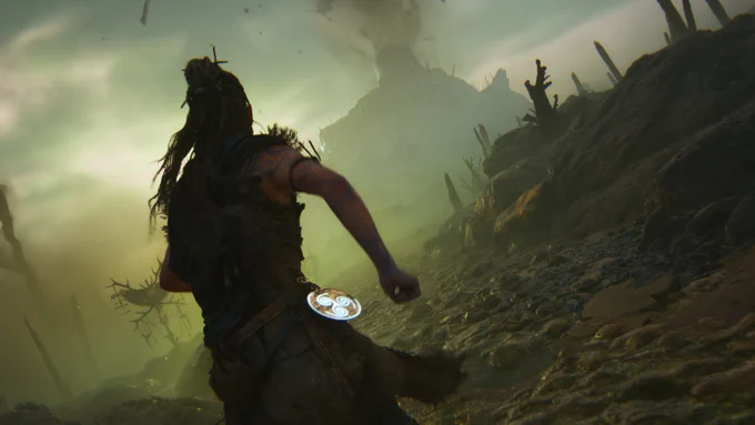Senua, a Celtic warrior, runs along a causeway towards a roundhouse atop a rocky hill.