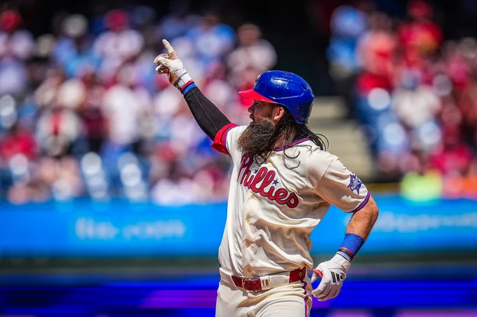 Brandon Marsh points to the bullpen as he rounds second base during his home run trot.